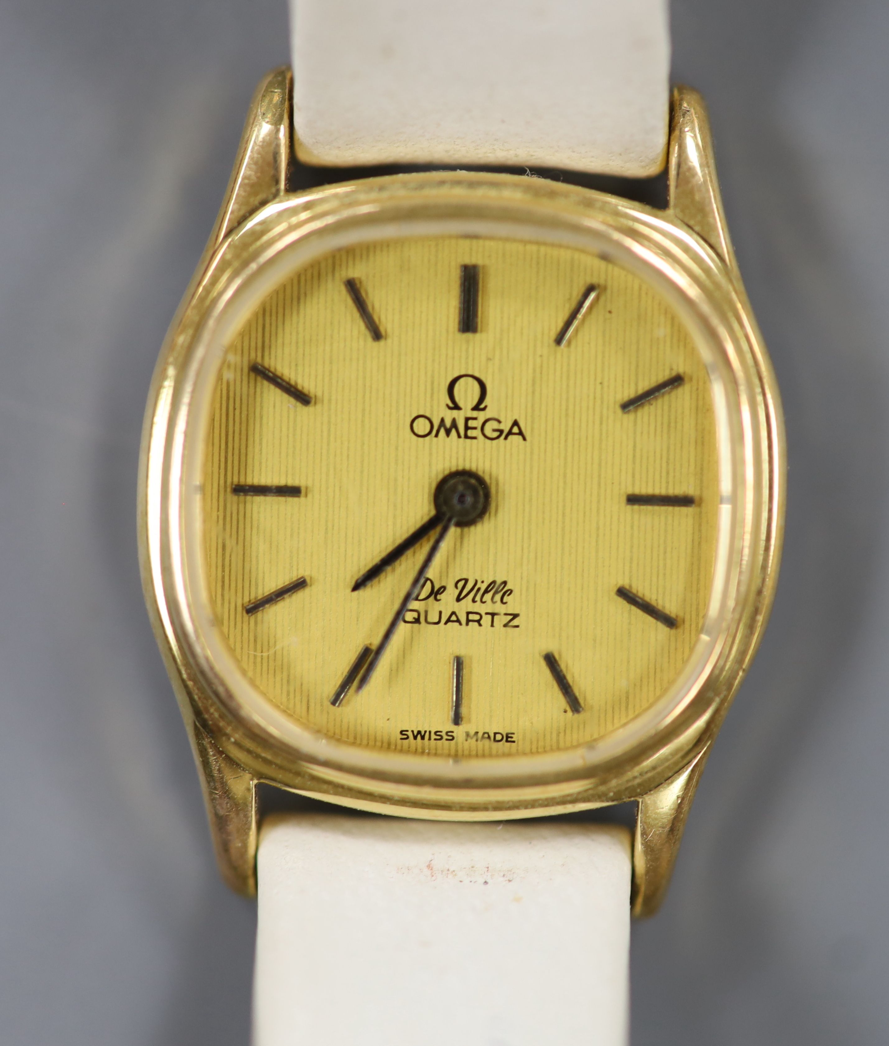 A lady's steel and gold plated Omega De Ville quartz wrist watch, on an associated leather strap.